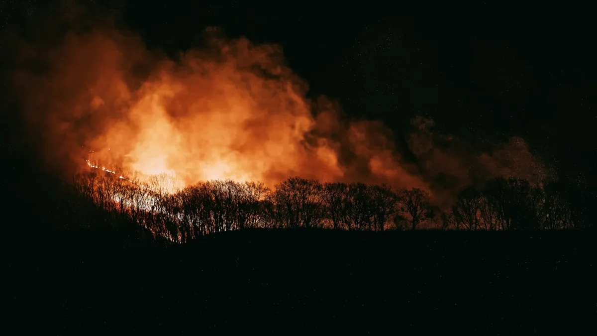 a large fire blazing in the night sky